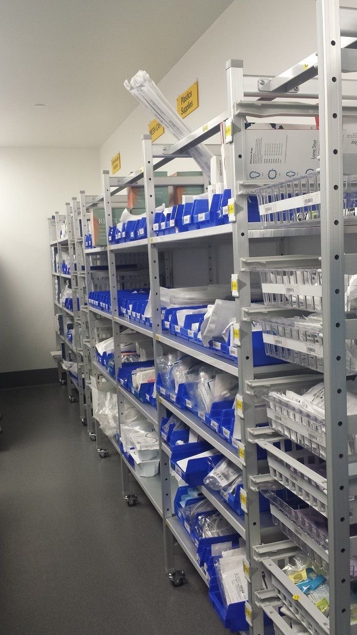 Laboratory supply store with shelves of labelled bins holding consumables and plasticware